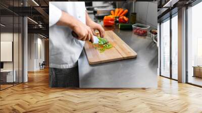 cooking food, profession and people concept - close up of male chef with knife chopping celery on cutting board at restaurant kitchen Wall mural