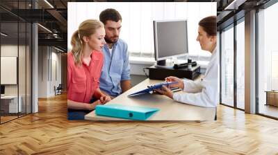 couple visiting doctor at family planning clinic Wall mural