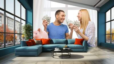 couple with money and piggybank ot table at home Wall mural