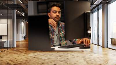 deadline, technology and people concept - close up of creative man with glasses working at night office and thinking Wall mural