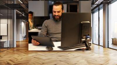 deadline, technology and people concept - creative man with tablet pc computer working late at night office Wall mural