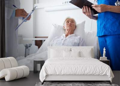 doctor and nurse visiting senior woman at hospital Wall mural