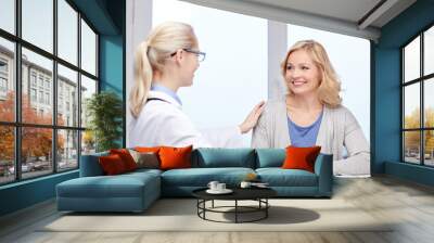 doctor talking to woman patient at hospital Wall mural