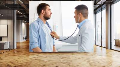 doctor with stethoscope and patient at hospital Wall mural