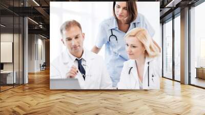 doctors looking at laptop on meeting Wall mural