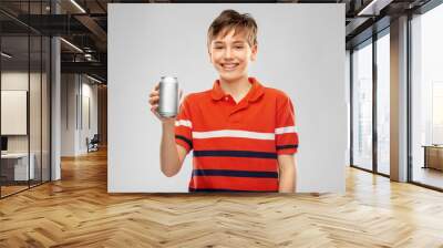 drinks and people concept - happy smiling boy in red polo t-shirt holding soda drink in tin can over grey background Wall mural