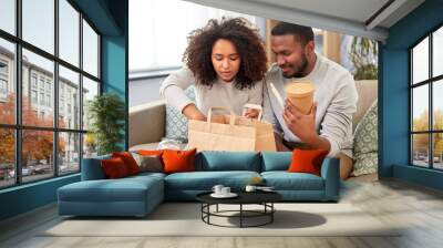 eating and people concept - happy african american couple with takeaway food and drinks at home Wall mural