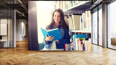 education, high school, university, learning and people concept - smiling student girl reading book at library Wall mural