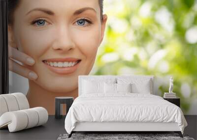 face and hand of smiling woman over green tarure Wall mural