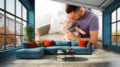 family, fatherhood and people concept - close up of father with little baby girl at home Wall mural