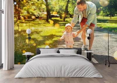 family, fatherhood and people concept - happy smiling father with baby daughter walking at summer park Wall mural