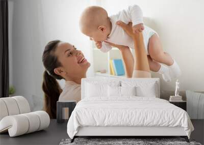 family, motherhood and people concept - happy mother playing with little baby boy at home Wall mural