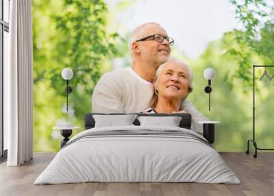 family, old age and relationships concept - happy senior couple over green natural background Wall mural