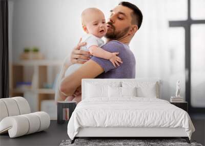 family, parenthood and people concept - father with crying little baby at home Wall mural