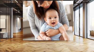 family and motherhood concept - close up of happy young asian mother with little baby at home Wall mural