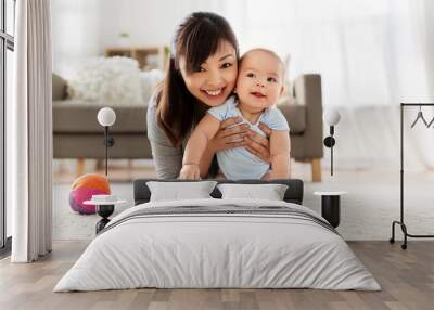 family and motherhood concept - happy smiling young asian mother with little baby at home Wall mural