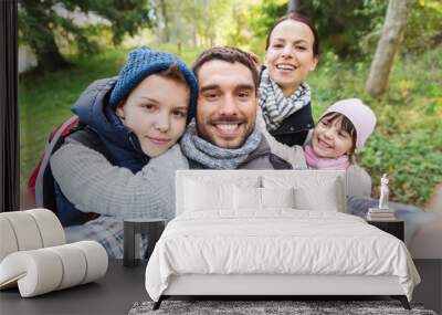 family with backpacks taking selfie and hiking Wall mural