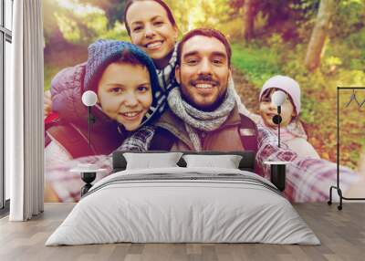 family with backpacks taking selfie and hiking Wall mural