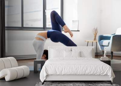 fitness, people and healthy lifestyle concept - young woman doing bridge pose at yoga studio Wall mural