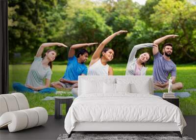 fitness, sport and healthy lifestyle concept - group of happy people exercising at summer park Wall mural