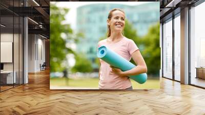 fitness, sport and healthy lifestyle concept - happy smiling woman with exercise mat at city park Wall mural