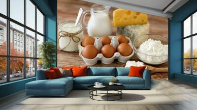 food and eating concept - close up of cottage cheese, jug of milk, homemade yogurt and chicken eggs on wooden table Wall mural