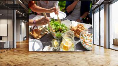 friends having dinner at summer garden party Wall mural