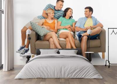 friendship, leisure and people concept - group of happy smiling friends sitting on sofa over white background Wall mural