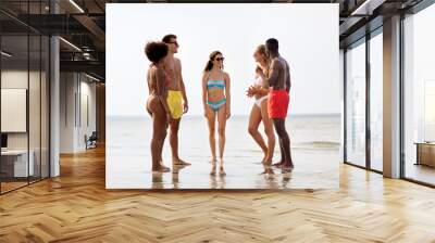 friendship, summer holidays and people concept - happy friends hugging on beach Wall mural