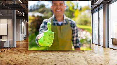 gardening and people concept - close up of happy smiling man in apron showing thumbs up at summer garden Wall mural