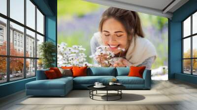 gardening and people concept - close up of happy young woman smelling chamomile flowers at summer garden Wall mural