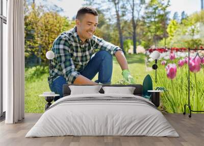 gardening and people concept - happy smiling middle-aged man with tools in box and flowers at summer garden Wall mural