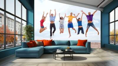 group of friends jumping on the beach Wall mural