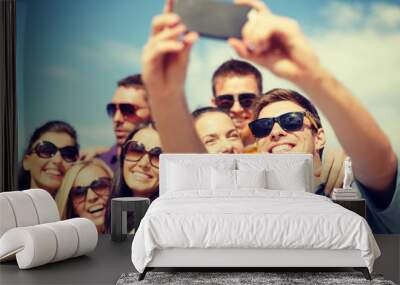 group of friends taking picture with smartphone Wall mural