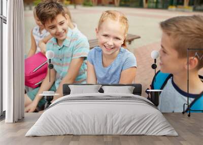 group of happy elementary school students talking Wall mural