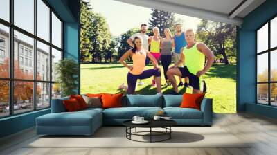 group of happy friends exercising outdoors Wall mural