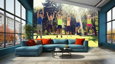 group of happy friends jumping high outdoors Wall mural