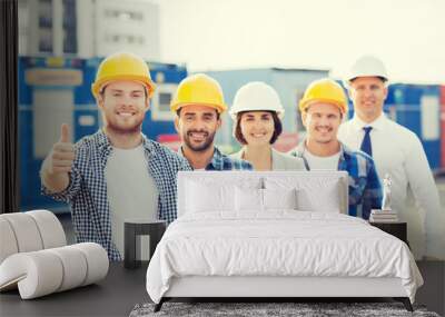 group of smiling builders in hardhats outdoors Wall mural