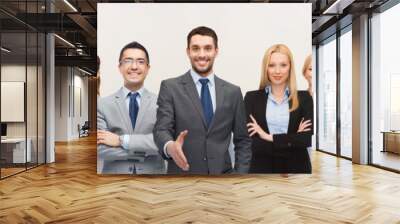 group of smiling businessmen making handshake Wall mural