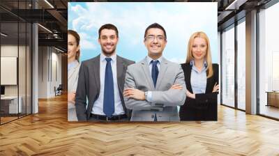 group of smiling businessmen over blue sky Wall mural