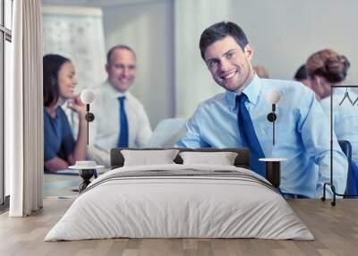 group of smiling businesspeople meeting in office Wall mural