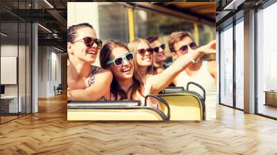 group of smiling friends traveling by tour bus Wall mural