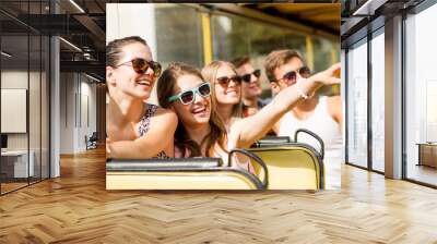 group of smiling friends traveling by tour bus Wall mural