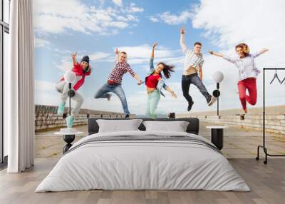 group of teenagers jumping Wall mural