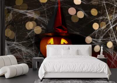 halloween and holiday decorations concept - jack-o-lantern in witch's hat with spider and broom in darkness over spiderweb and lights Wall mural