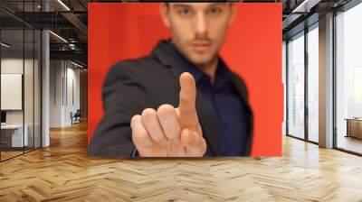 handsome man in suit pressing virtual button Wall mural