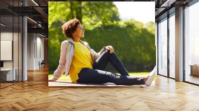 happy african american young woman in summer park Wall mural