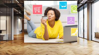 happy african woman with laptop and credit card Wall mural