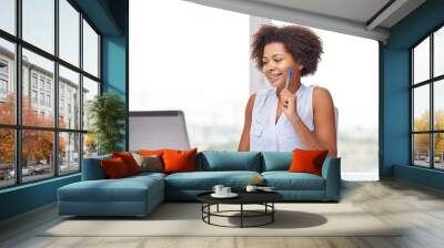 happy african woman with laptop at office Wall mural