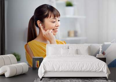 happy asian woman with tablet pc and earphones Wall mural